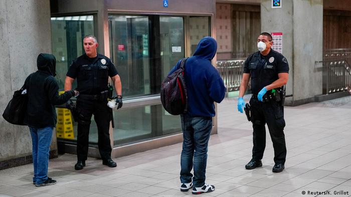 Los Angeles police speaking to people at a public transport station (Reuters/K. Grillot)