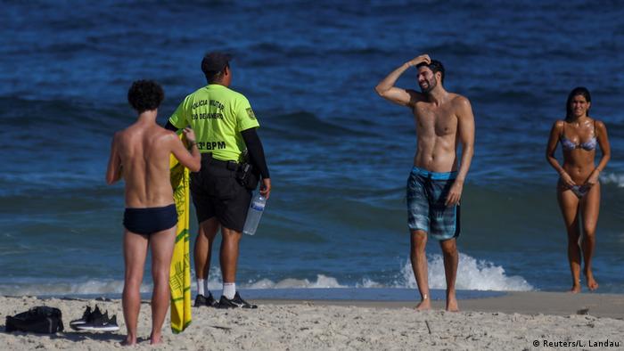 Police in Rio de Janeiro, Brazil, speaking to beachgoers (Reuters/L. Landau)