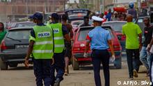 Police officers walk at the Avo Kumbi square in Luanda, Angola, on April 2, 2020. - Angola is in a state of emergency to help stop the spread of the COVID-19 coronavirus, which means severe restrictions are in place. (Photo by Osvaldo Silva / AFP)