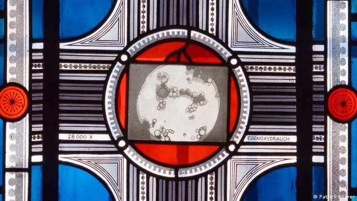 Stained glass window by Franz Pauli, an abstract cross with a large circle in the middle, blue, red and gray