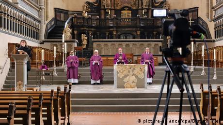 Priests holding mass in an empty church