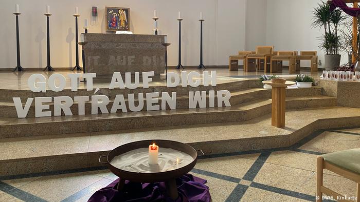 A message reading in God we trust at the altar of the Holy Spirit Catholic Church in Berlin's Charlottenburg