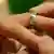 A wedding ring being put on