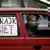 Women drive their car with a "Women's Strike" banner in protest