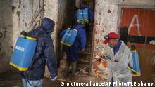 In this in Wednesday, March 25, 2020 photo, volunteers disinfect a housing complex to prevent the spread of coronavirus in Sale, near Rabat, Morocco. Hundreds of people live in crowded rooms in this Moroccan housing complex with no running water and no income left because of the coronavirus lockdown measures. However, volunteers come to help clean as the government tries to protect the population from virus while not punishing the poor. (AP Photo/Mosa'ab Elshamy) |