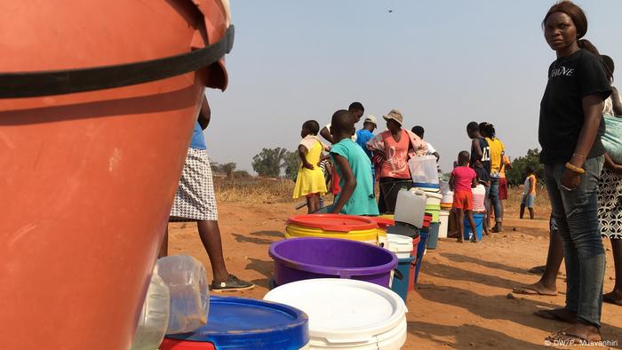 People queue for water in Zimbabwe.