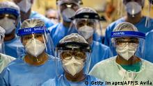 A group of doctors working with patients infected with the novel coronavirus COVID-19 wear face shields at the Intensive Care Unit of the Hospital de Clinicas in Porto Alegre, Brazil, on April 15, 2020. - With Brazilians increasingly ignoring health officials' warnings to stay home -- encouraged by their far-right president Jair Bolsonaro, who has condemned the hysteria over the virus -- predictions for how the pandemic will play out in the hardest-hit country in Latin America are getting dire. (Photo by Silvio AVILA / AFP) (Photo by SILVIO AVILA/AFP via Getty Images)