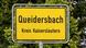 The road sign entering the Queidersbach town in Germany, near Kaiserslautern, picture in 2018. The road sign entering the Queidersbach town in Germany, near Kaiserslautern, picture in 2018.