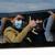 Unaccompanied children from overcrowded migrant camps in Greece gesture as they ride a bus after their arrival at the airport in Hanover