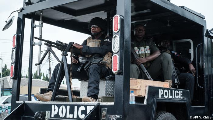 Nigerian SWAT police officers inside a truck.