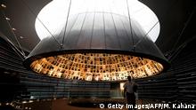 A picture taken on April 20, 2020, shows a an employee leaving the Hall of Names, bearing names and pictures of Jewish Holocaust victims, at the Yad Vashem Holocaust memorial museum in Jerusalem. - Movement and travel restrictions in place to contain the pandemic have forced this week's Holocaust Remembrance Day -- Yom HaShoah in Hebrew -- to be exclusively digital for the first time. In a normal year, symbolic events are organised at various locations, notably with survivors at the sites in Europe where the Nazis built concentration and extermination camps. This year, testimonials from survivors will be streamed online and featured in a pre-recorded ceremony to be broadcast in Israel by Jerusalem's Yad Vashem Holocaust memorial centre, when Yom HaShoah begins on this evening. (Photo by MENAHEM KAHANA / AFP) (Photo by MENAHEM KAHANA/AFP via Getty Images)
