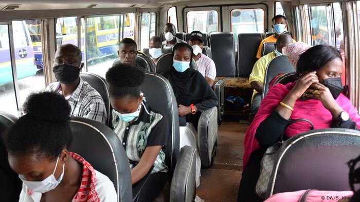 Passengers in Dar es Salaam wearing face masks inside a mini van.