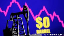 A 3D-printed oil pump jack is seen in front of a displayed stock graph and $0 Barrel words in this illustration picture, April 20, 2020. REUTERS/Dado Ruvic/Illustration