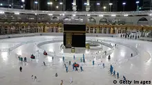 TOPSHOT - A picture taken on April 24, 2020, shows sanitation workers disinfection the area arround the Kaaba in Mecca's Grand Mosque, on the first day of the Islamic holy month of Ramadan, amid unprecedented bans on family gatherings and mass prayers due to the coronavirus (COVID-19) pandemic. (Photo by STR / AFP) (Photo by STR/AFP via Getty Images)
