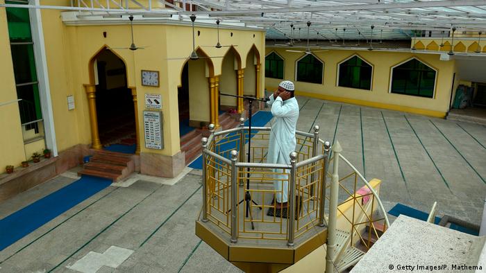 A muezzin recites the call to prayer at the Jame Masjid in Kathmandu
