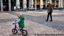 Boy rides a bicycle with her mother after restrictions were partially lifted for children for the first time in six weeks, during the coronavirus disease (COVID-19) outbreak in Madrid, April 26, 2020. |