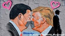 TOPSHOT - A mural painting by graffiti artist Eme Freethinker features likenesses of US President Donald Trump (R) and Chinese premier Xi Jinping wearing face covers in Berlin on April 28, 2020 amid the new coronavirus COVID-19 pandemic. (Photo by John MACDOUGALL / AFP) (Photo by JOHN MACDOUGALL/AFP via Getty Images)