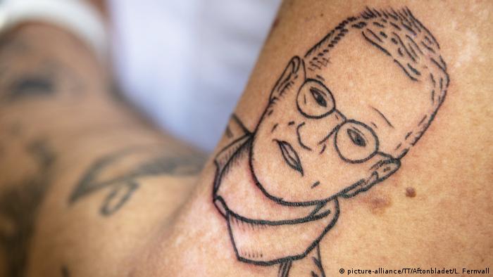 The face of Anders Tegnell is tattooed on a person's arm