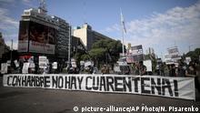 Activists carry the Spanish message: With hunger there is no quarantine during a protest marking May Day, or International Workers' Day, amid a government-ordered lockdown to curb the spread of the new coronavirus in Buenos Aires, Argentina, Friday, May 1, 2020. (AP Photo/Natacha Pisarenko) |