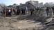 Rescue workers and officials around a crater made by the bomb blast Rescue workers and officials around a crater made by the bomb blast