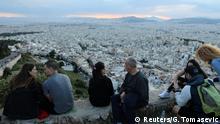 People sit overlooking Athens following the coronavirus disease (COVID-19) outbreak, Greece, May 3, 2020. REUTERS/Goran Tomasevic