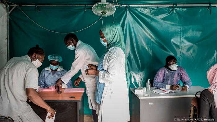 Health workers screen and direct patients at a hospital in Dakar