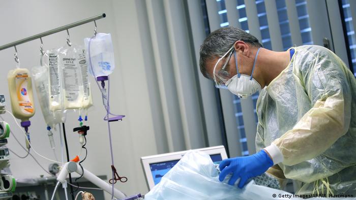A doctor takes care of a COVID-19 patient in an intensive care unit at a hospital in Magdeburg, Germany