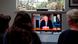 A family gather around the television to watch Britain's Prime Minister Boris Johnson give a televised message to the nation A family gather around the television to watch Britain's Prime Minister Boris Johnson give a televised message to the nation