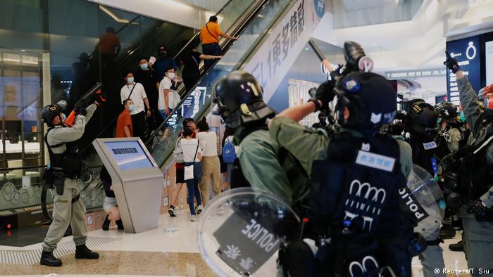 Police point their weapons in a Hong Kong mall