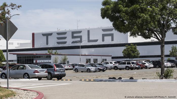 Tesla factory in Fremont with cars parked outside