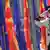 A person salutes flags from North Macedonia and the EU