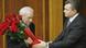 Ukrainian President Viktor Yanukovich, right, greets new Prime Minister, Mykola Azarov in parliament with roses Ukrainian President Viktor Yanukovich, right, greets new Prime Minister, Mykola Azarov in parliament with roses