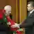 Ukrainian President Viktor Yanukovich, right, greets new Prime Minister, Mykola Azarov in parliament with roses