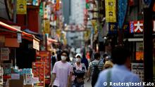 May 14, 2020***
Passersby wearing protective face masks walk on the street as the spread of the coronavirus disease (COVID-19) continues in Tokyo, Japan May 14, 2020. REUTERS/Issei Kato