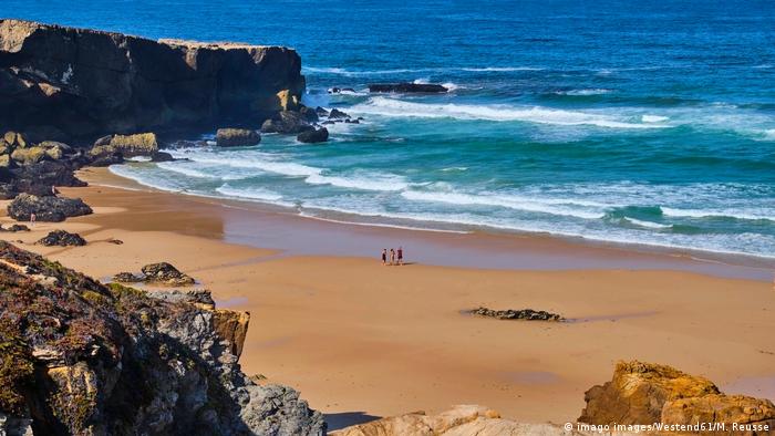 Portugal, people walking on an empty beach at Alentejo Vila Nova de Milfontes 