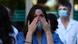 A hospital worker cries while people applaud A hospital worker cries while people applaud