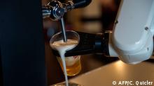 The Beer Cart robot made by the Spanish based Macco Robotics foodtech company, pours a beer at the bar 'La Gitana Loca' in the Seville on May 17, 2020, during the national lockdown to prevent the spread of the COVID-19 disease. - Spain reported 87 coronavirus deaths over a 24-hour period, the first time in two months that the daily toll has dropped below 100. The number came a day before Spain is to further relax lockdown measures across the country, but not in Madrid and Barcelona. (Photo by CRISTINA QUICLER / AFP)