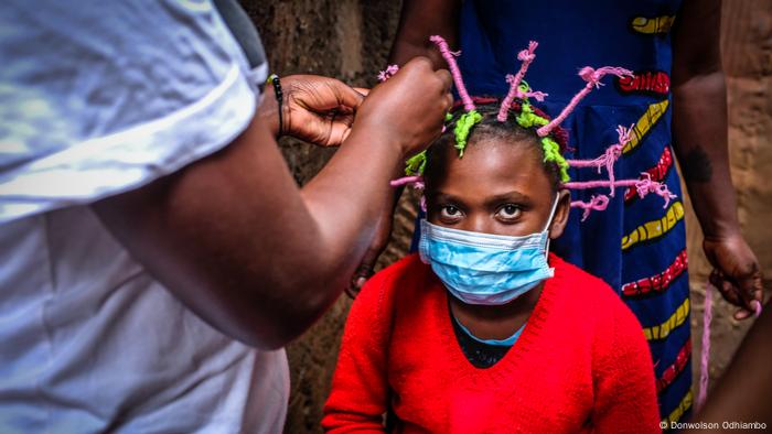 A child with hair styled in the shape of the coronavirus 