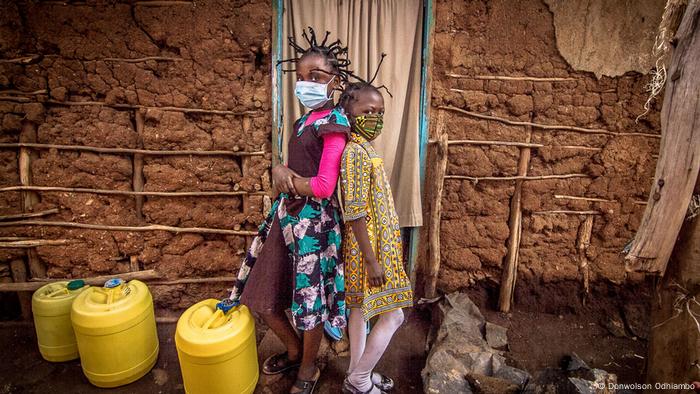 Two children with hair styled in the shape of the coronavirus 