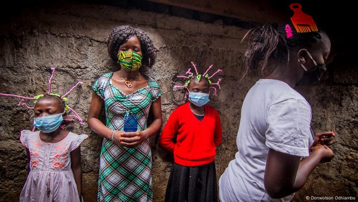 Two children with hair styled in the shape of the coronavirus 