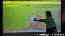 A scientist at India Meteorological Department Earth System Science Organisation, points to a section of the screen showing the position of the Cyclone Amphan to media people inside his office in Kolkata, India, May 19, 2020. REUTERS/Rupak De Chowdhuri