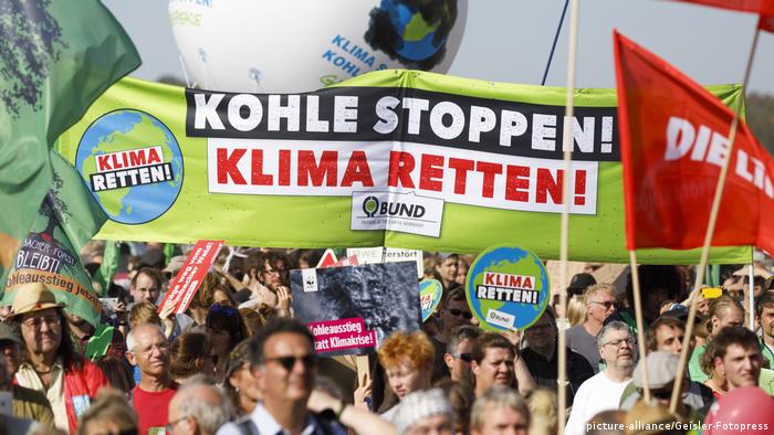 Demonstranten mit Bannern 'Wald retten - Kohle stoppen' am Hambacher Wald