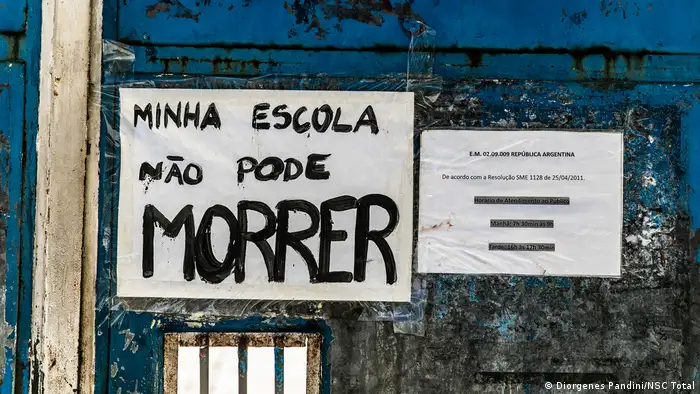 My school must not die, reads a sign written by a student on the gate of Republica Argentina High School in Rio de Janeiro, Brazil