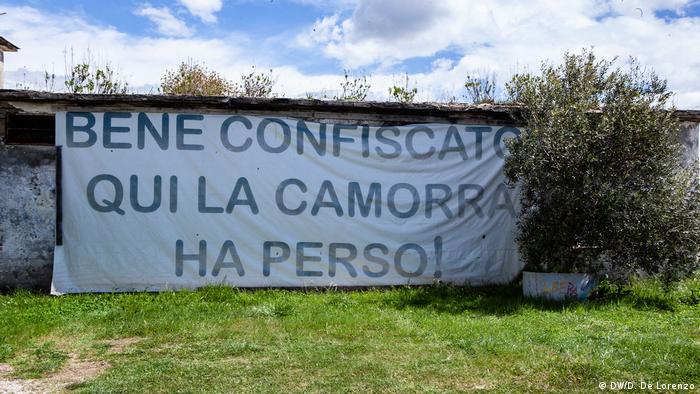 A sign reading Seized property, here Camorra hast lost outside a dairy farm in Campania