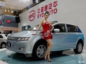 A model poses next to a new BYD e6 electric vehicle of Chinese automaker BYD Auto at the Shanghai International Auto Show on its opening day, Monday, April 20, 2009 in Shanghai, China. World automakers were launching 13 new models Monday as they converged on China's commercial capital for the show, a key showcase for the only major growing car market. (AP Photo/Eugene Hoshiko)
