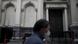 Men walk in front of the central bank at the financial district during a government-ordered lockdown to curb the spread of COVID-19 in Buenos Aires, Men walk in front of the central bank at the financial district during a government-ordered lockdown to curb the spread of COVID-19 in Buenos Aires,