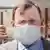 Глава правительства Тюрингии Бодо Рамелов надевает защитную маску