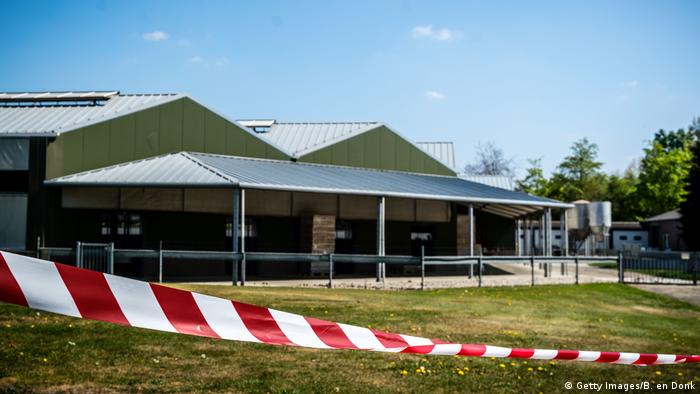 This general view shows barrier tape cordoning off buildings of a mink farm at Beek en Donk, eastern Netherlands on April 26, 2020, after tests showed that animals within had been infected with the new coronavirus (COVID-19).