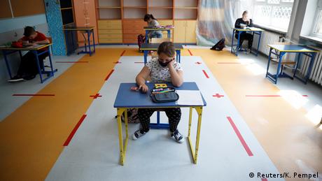 Four pupils study in a classroom (Reuters/K. Pempel)