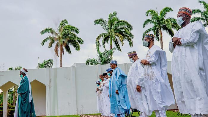Buhari and his family observing Eid prayers at his villa